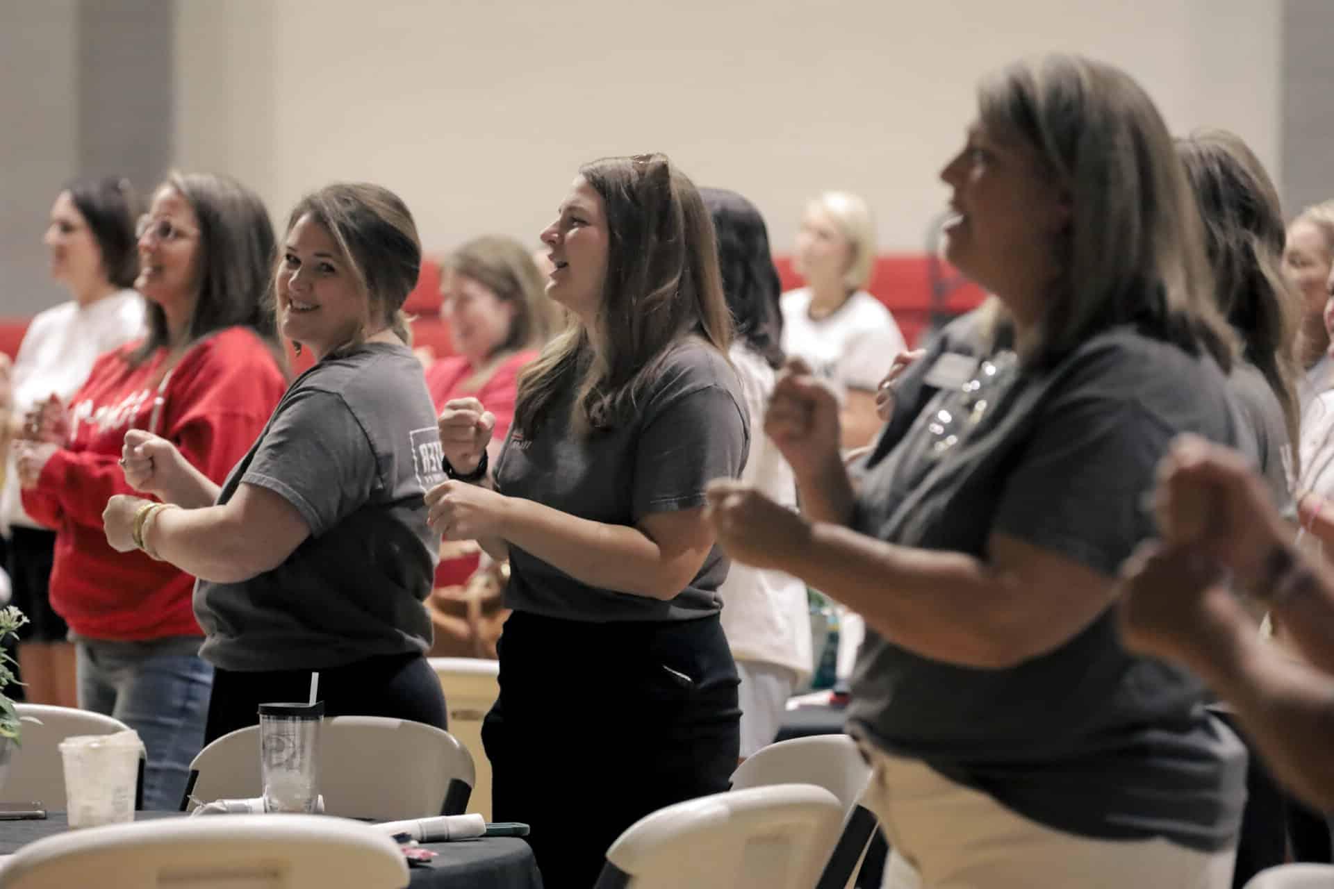 Staff participates in Praise and Worship at Back to School Breakfast.